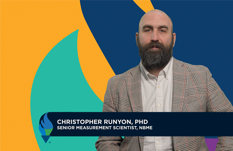 Photo of Christopher Runyon, Ph.D. presenting a slide titled “What is ChatGPT” to an audience